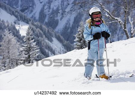 Girl with skis standing on snow View Large Photo Image Stock Image - Girl with skis standing on snow. Fotosearch