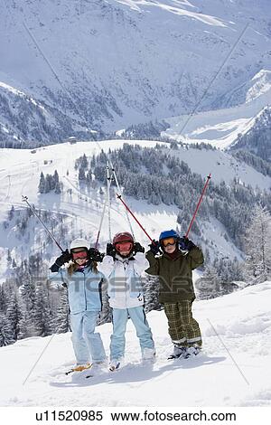 Group of kids standing in snow with skis View Large Photo Image Stock Photography - Group of kids standing in snow with skis. Fotosearch