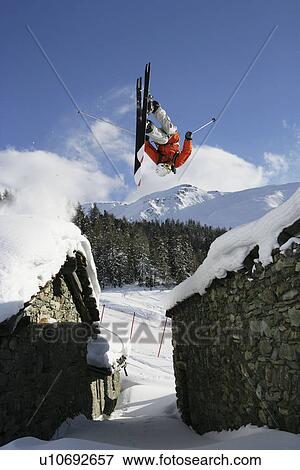 Skier jumping between buildings View Large Photo Image Stock Photo - Skier jumping between buildings. Fotosearch