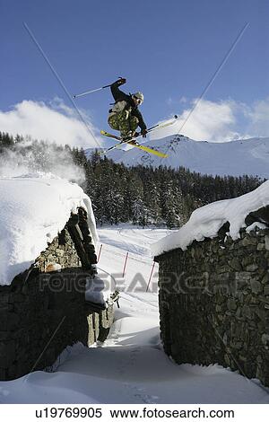 Skier jumping over buildings View Large Photo Image Stock Photography - Skier jumping over buildings. Fotosearch