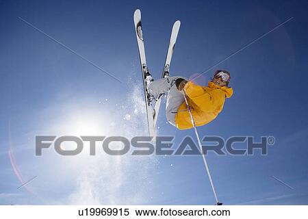 Skier jumping shot from bellow View Large Photo Image Stock Photography - Skier jumping shot from bellow. Fotosearch