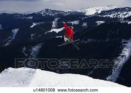 Skier jumping with trees in background View Large Photo Image Stock Photo - Skier jumping with trees in background. Fotosearch