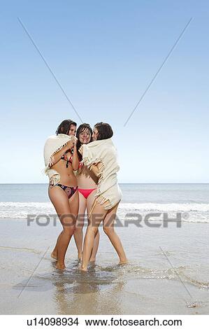 Three girls sharing a blanket View Large Photo Image Picture - Three girls sharing a blanket. Fotosearch