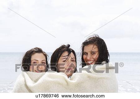 Stock Photograph - Three girls sharing a blanket. Fotosearch