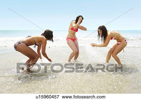 Three girls splashing each other View Large Photo Image Stock Photo - Three girls splashing each other. Fotosearch