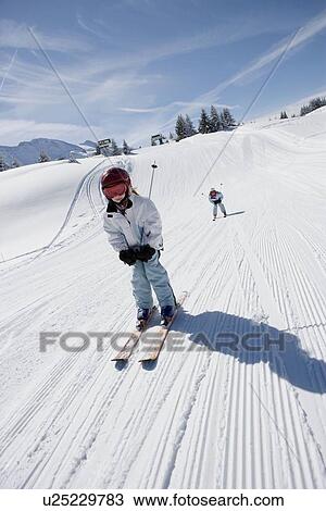 Two girls skiing View Large Photo Image Stock Image - Two girls skiing. Fotosearch