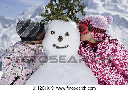 Two girls with a snowman View Large Photo Image Stock Photo - Two girls with a snowman. Fotosearch