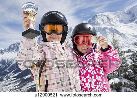 Stock Image - Two girls with trophies. Fotosearch