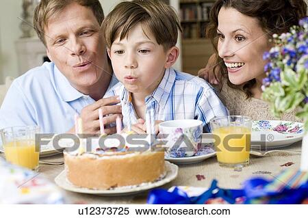 Boy blow out his birthday candles View Large Photo Image Stock Photography - Boy blow out his birthday candles. Fotosearch