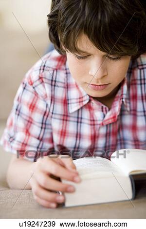 Boy reading a book View Large Photo Image Stock Photo - Boy reading a book. Fotosearch