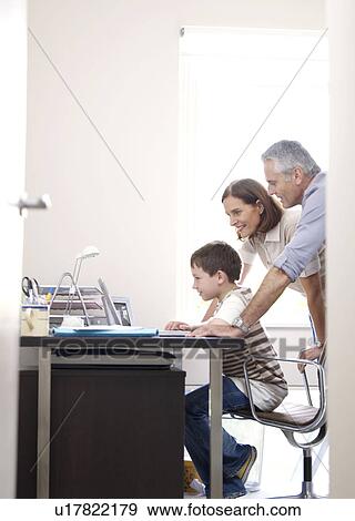 Family at laptop in home office View Large Photo Image Stock Photo - Family at laptop in home office. Fotosearch
