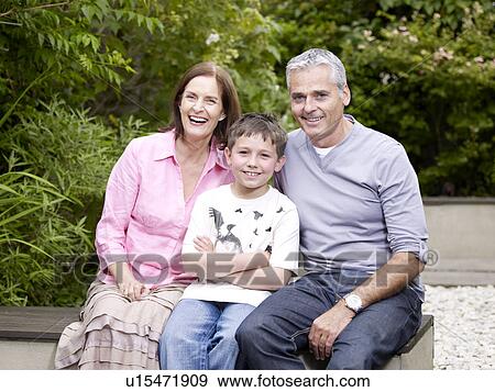 Family sitting on patio in garden View Large Photo Image Stock Photo - Family sitting on patio in garden. Fotosearch