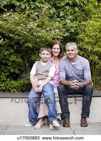 Family sitting together in garden View Large Photo Image Stock Image - Family sitting together in garden. Fotosearch