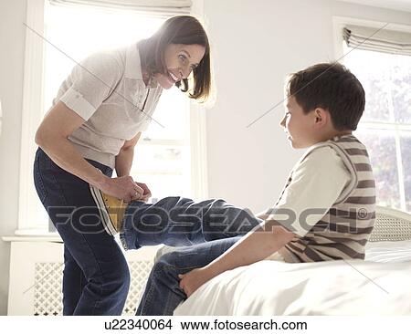 Mother putting shoes on young son View Large Photo Image Picture - Mother putting shoes on young son. Fotosearch