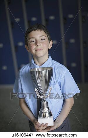 School boy holding trophy View Large Photo Image Stock Photo - School boy holding trophy. Fotosearch