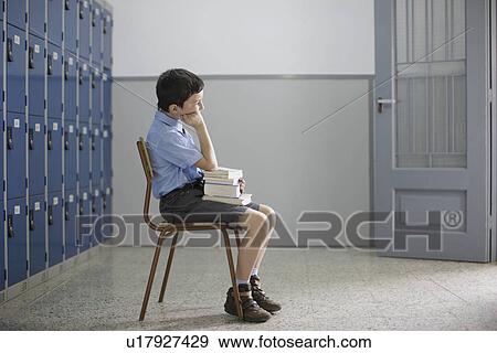 School boy sitting with books View Large Photo Image Stock Photo - School boy sitting with books. Fotosearch