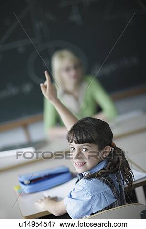 School girl raising hand in class View Large Photo Image Stock Photo - School girl raising hand in class. Fotosearch