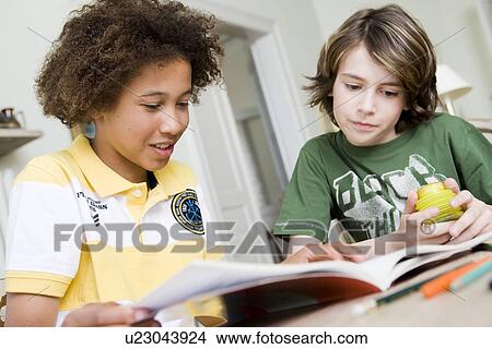 Picture - Two boys doing homework. Fotosearch