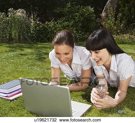 2 women in park, working on computer View Large Photo Image Stock Image - 2 women in park, working on computer. Fotosearch