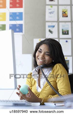 Stock Image - Businesswoman using telephone. Fotosearch