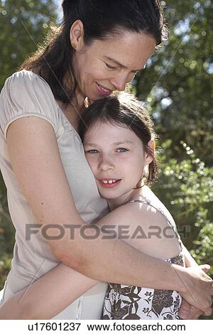 Mother and daughter embracing View Large Photo Image Stock Photo - Mother and daughter embracing. Fotosearch
