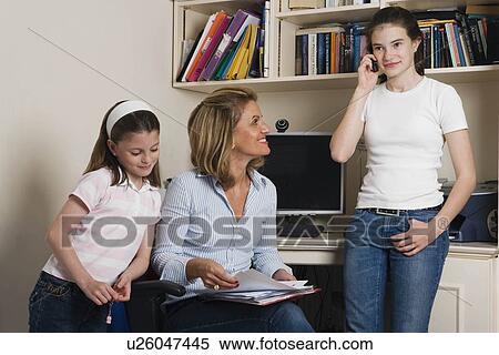 Mother with children working from home View Large Photo Image Stock Photography - Mother with children working from home. Fotosearch