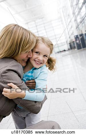 Woman embracing girl View Large Photo Image Stock Photography - Woman embracing girl. Fotosearch