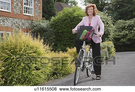 Woman on bicycle View Large Photo Image Stock Photo - Woman on bicycle. Fotosearch