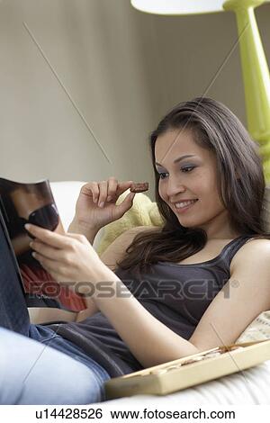Stock Photograph - Woman relaxing on sofa. Fotosearch