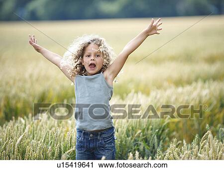 Young girl jumping out of cornfield View Large Photo Image Stock Image - Young girl jumping out of cornfield. Fotosearch