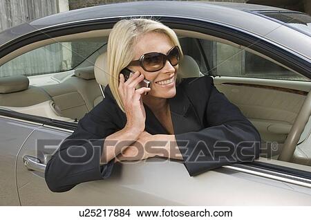 Business woman on phone in car View Large Photo Image Picture - Business woman on phone in car. Fotosearch