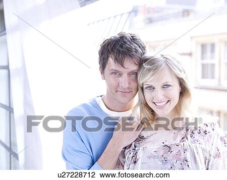 Couple by window facing camera together View Large Photo Image Stock Image - Couple by window facing camera together. Fotosearch