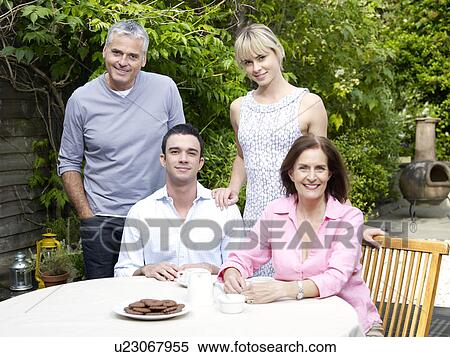 Family afternoon in summertime garden View Large Photo Image Stock Photography - Family afternoon in summertime garden. Fotosearch