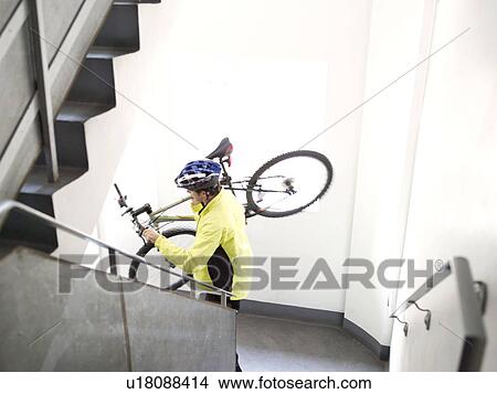 Man walking downstairs with bike View Large Photo Image Picture - Man walking downstairs with bike. Fotosearch