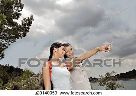 Two woman looking at horizon View Large Photo Image Stock Photo - Two woman looking at horizon. Fotosearch
