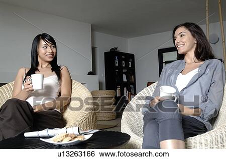 Two women having a chat View Large Photo Image Stock Photograph - Two women having a chat. Fotosearch