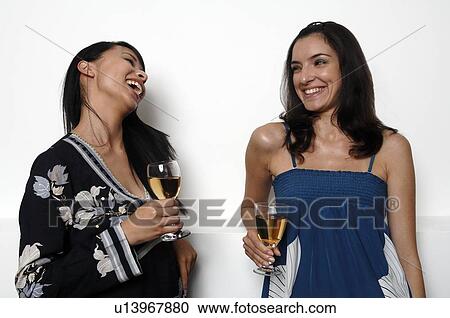 Two women having a drink View Large Photo Image Stock Image - Two women having a drink. Fotosearch