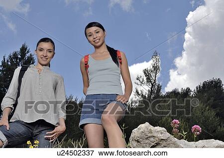 Stock Photo - Two women walking through nature. Fotosearch