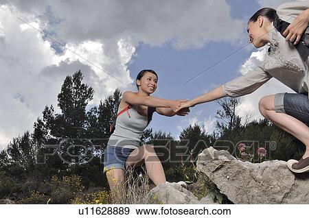 Woman helping out an other one View Large Photo Image Stock Photo - Woman helping out an other one . Fotosearch