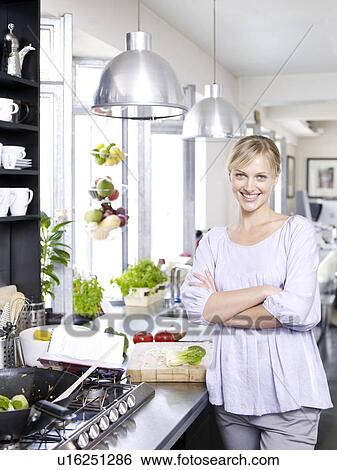 Woman in kitchen cooking food View Large Photo Image Stock Photograph - Woman in kitchen cooking food. Fotosearch