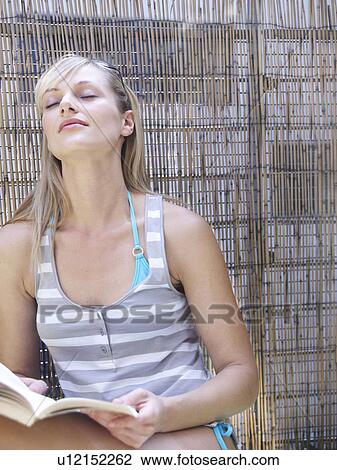 Woman reading on city balcony View Large Photo Image Stock Image - Woman reading on city balcony. Fotosearch