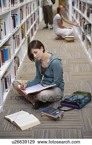 Stock Photo - Young students in a library. Fotosearch