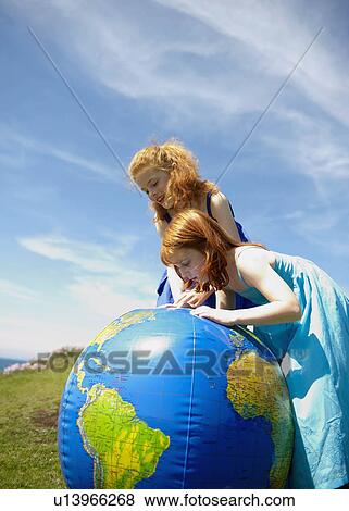 2 girls looking at inflatable globe View Large Photo Image Stock Photo - 2 girls looking at inflatable globe. Fotosearch