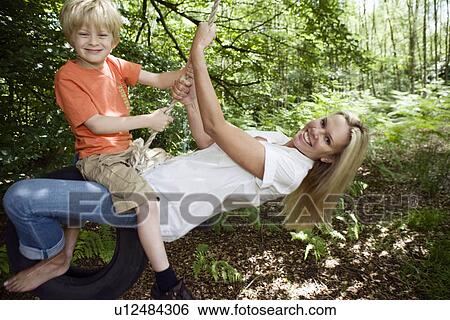 Boy and mom on tire swing View Large Photo Image Stock Photograph - Boy and mom on tire swing. Fotosearch