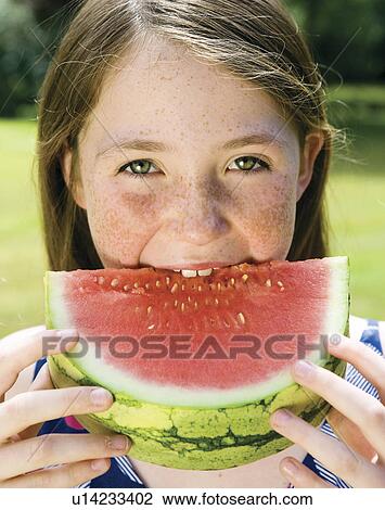 Girl eating a watermelon View Large Photo Image Stock Image - Girl eating a watermelon. Fotosearch