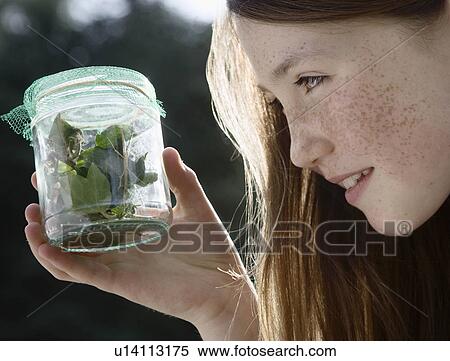 Girl holding jar of insects View Large Photo Image Stock Photography - Girl holding jar of insects. Fotosearch