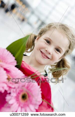 Girl smiling holding flowers View Large Photo Image Stock Photo - Girl smiling holding flowers. Fotosearch