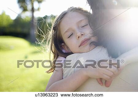 Mother and daughter embracing View Large Photo Image Stock Image - Mother and daughter embracing. Fotosearch