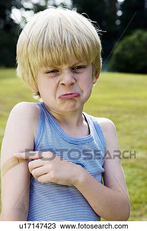 Stock Image - Portrait of boy with plaster. Fotosearch