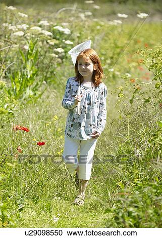 Young girl in field with butterfly net View Large Photo Image Stock Image - Young girl in field with butterfly net. Fotosearch